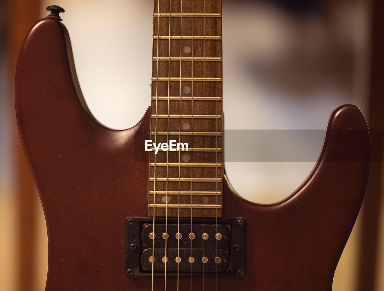 CLOSE-UP OF GUITAR IN THE DARK