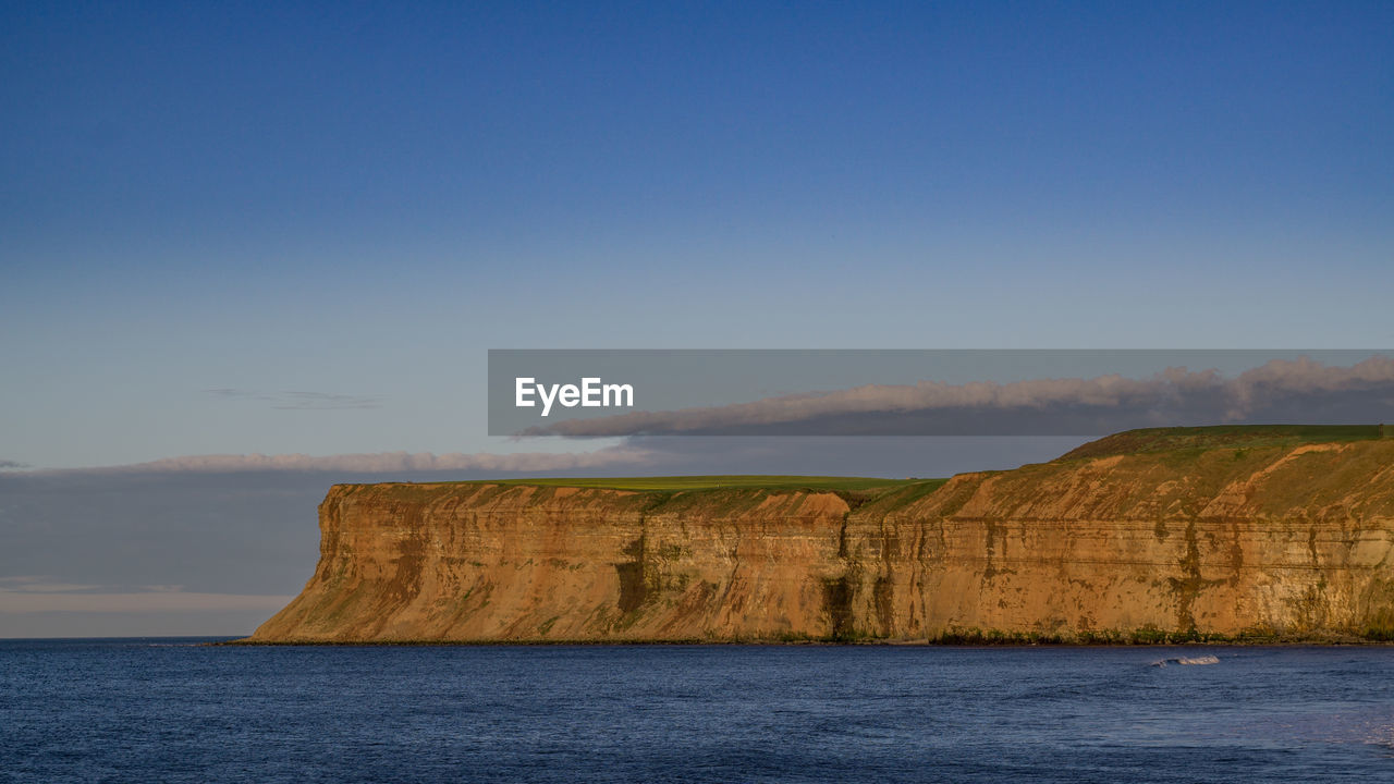 Scenic view of sea against blue sky