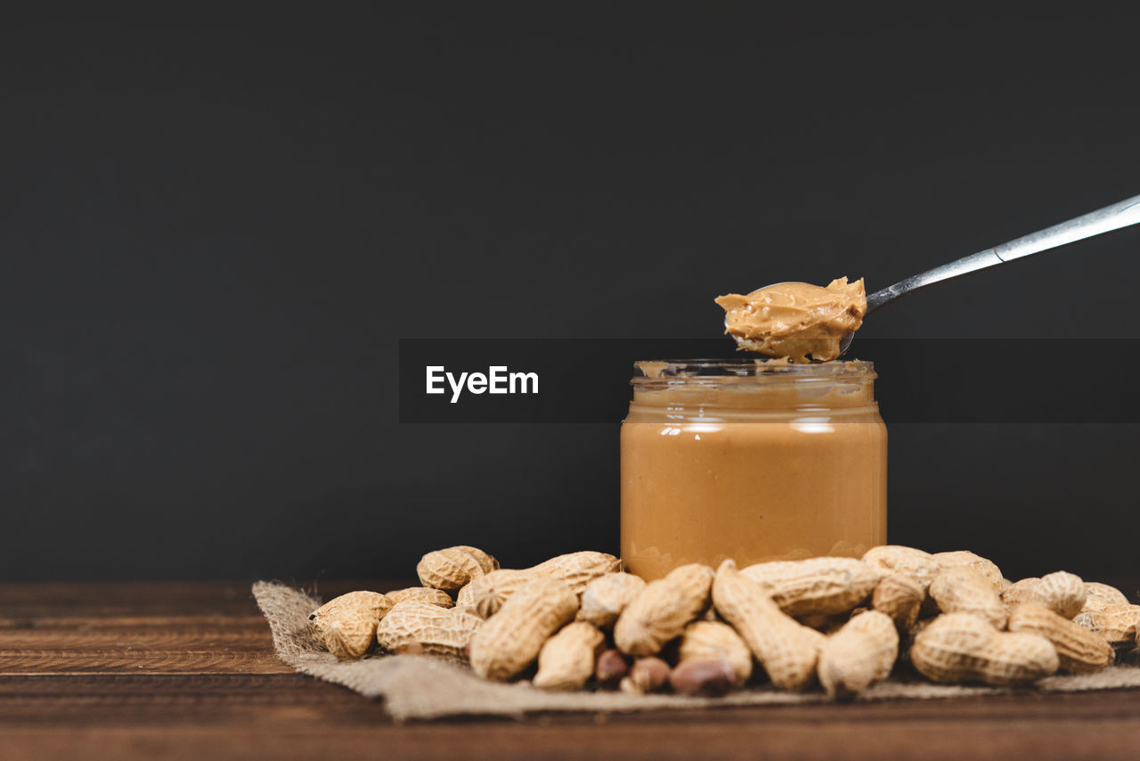 Peanut butter,groundnut and spoon on a wooden table.