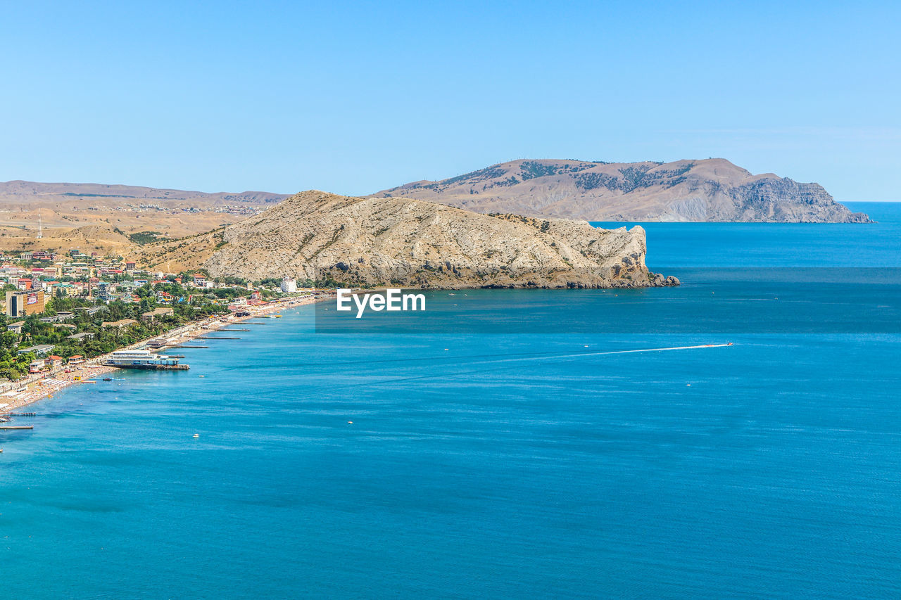 Scenic view of sea against clear blue sky