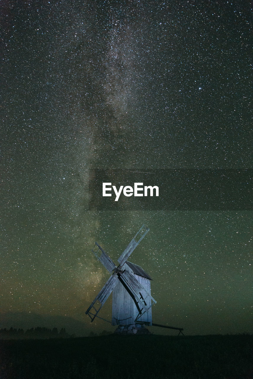 Traditional windmill against star field at night