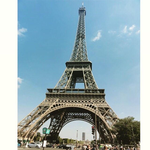 LOW ANGLE VIEW OF EIFFEL TOWER WITH EIFFEL TOWER IN BACKGROUND