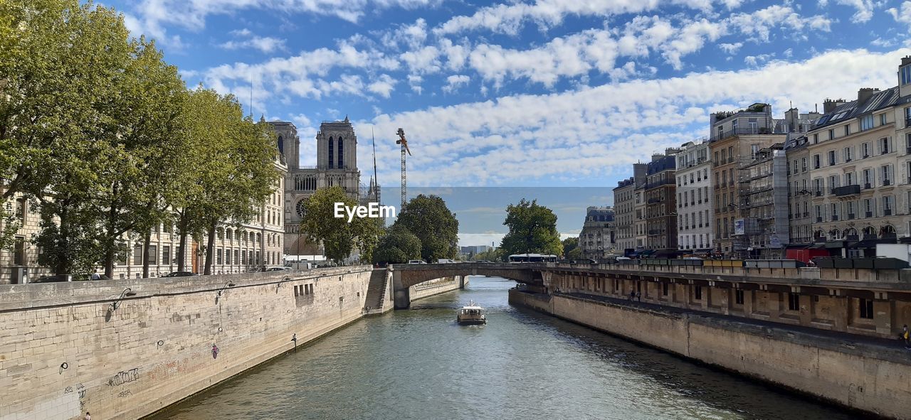 architecture, built structure, canal, water, building exterior, waterway, city, sky, nature, travel destinations, bridge, tree, cloud, travel, plant, transportation, tourism, building, cityscape, day, waterfront, body of water, outdoors, history, the past, town, no people