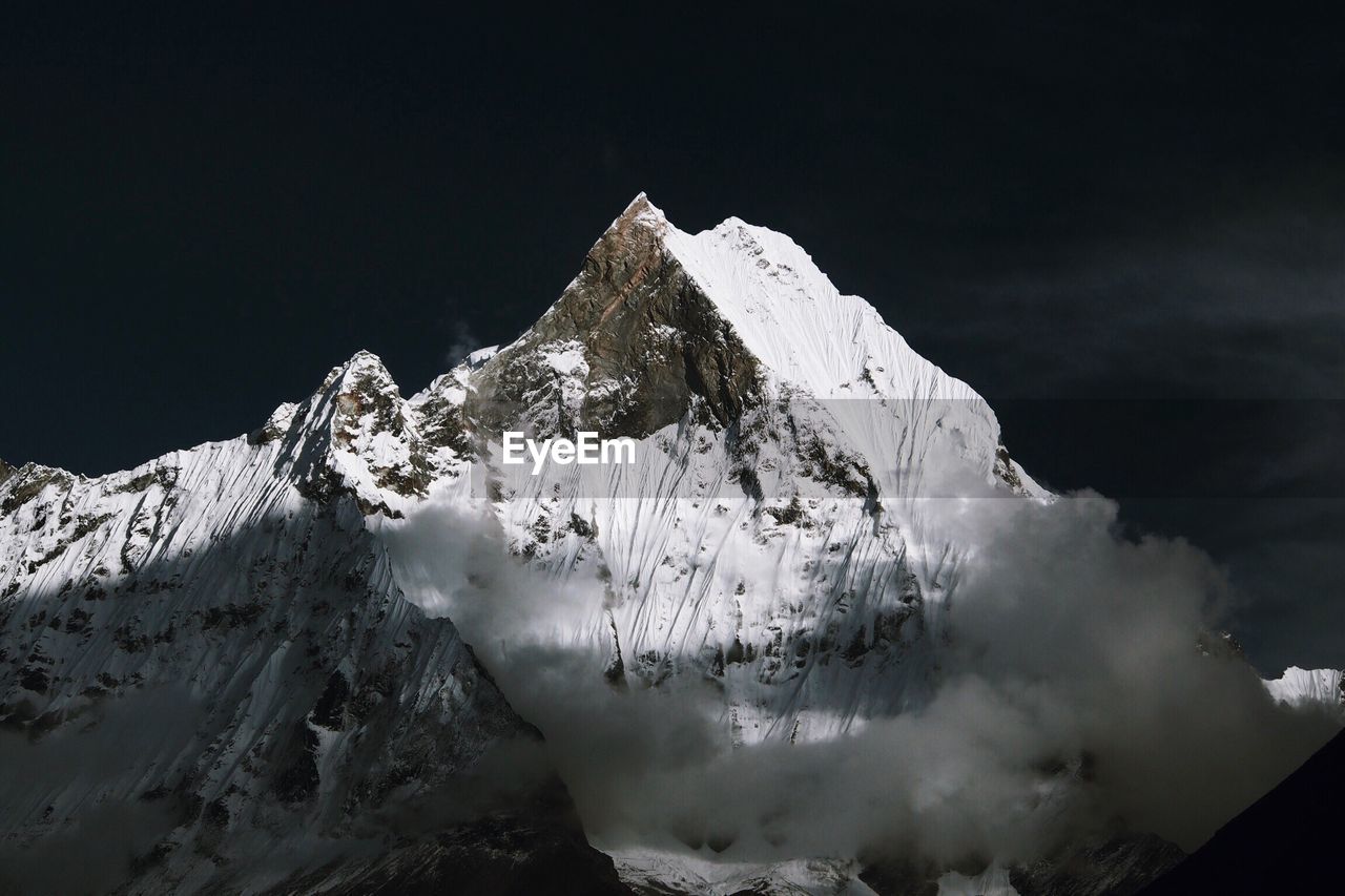 Scenic view of snow covered mountain against sky