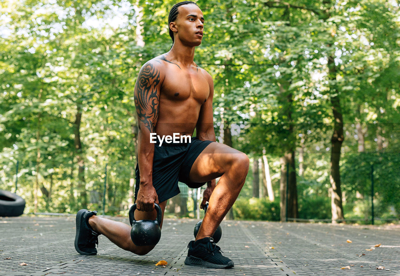 Full length of man exercising on footpath