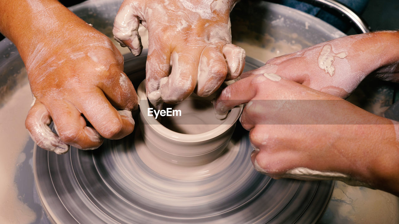 Hands of a female potter creating pottery on a wheel. open lesson on pottery. concept of handwork