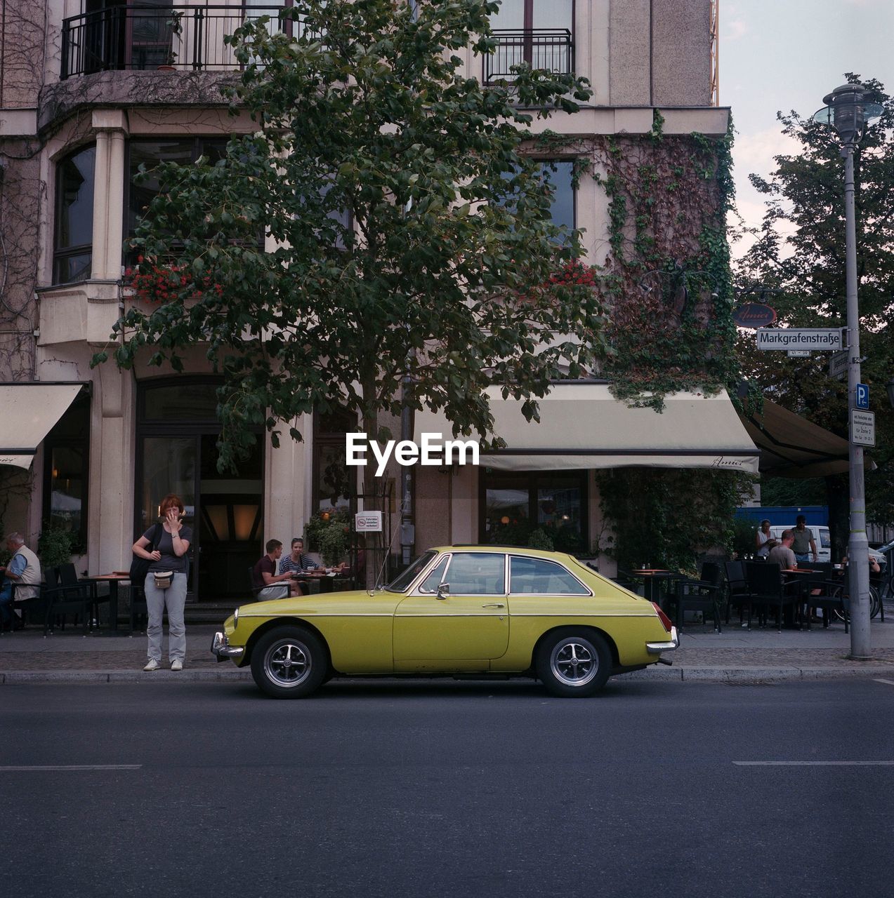 CAR ON STREET AGAINST BUILDINGS