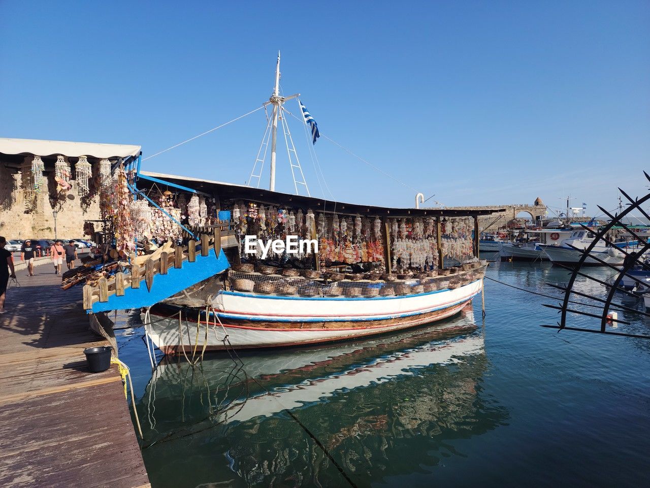 boats in sea against clear blue sky