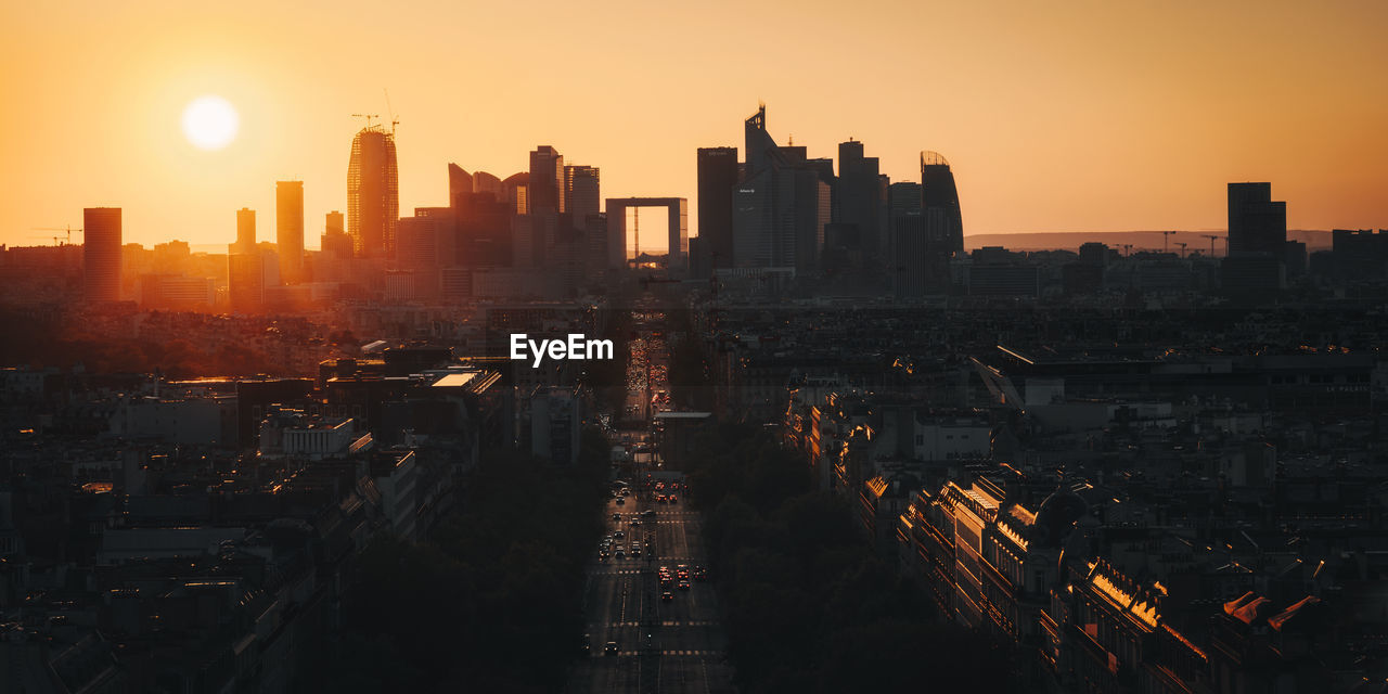 High angle view of illuminated cityscape at sunset