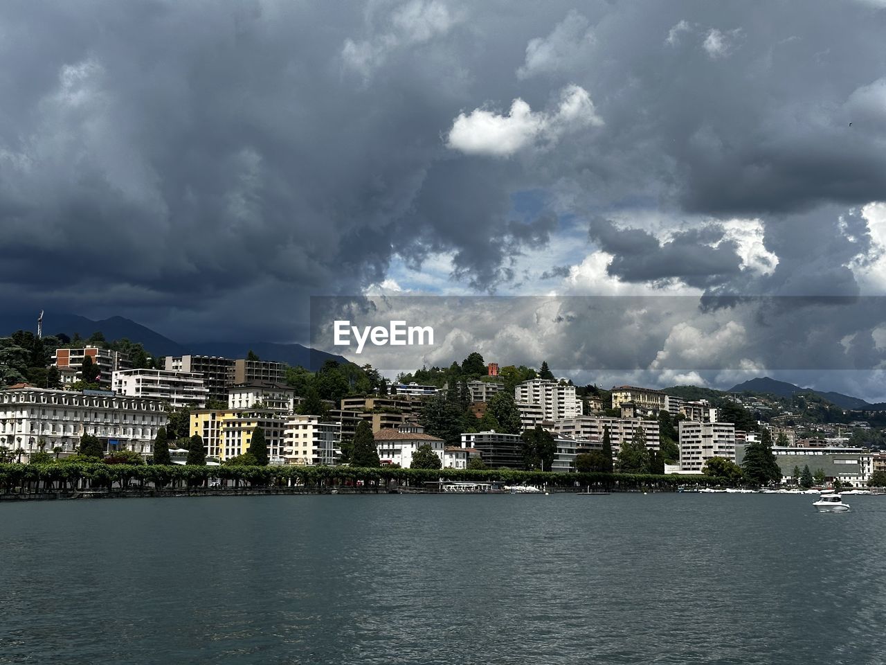 architecture, city, building exterior, water, built structure, building, sky, cloud, cityscape, horizon, nature, sea, landscape, travel destinations, residential district, environment, storm, no people, coast, house, skyline, travel, dramatic sky, overcast, outdoors, waterfront, storm cloud, tourism, city life, land, urban skyline, dusk, bay, town, beauty in nature, beach, scenics - nature