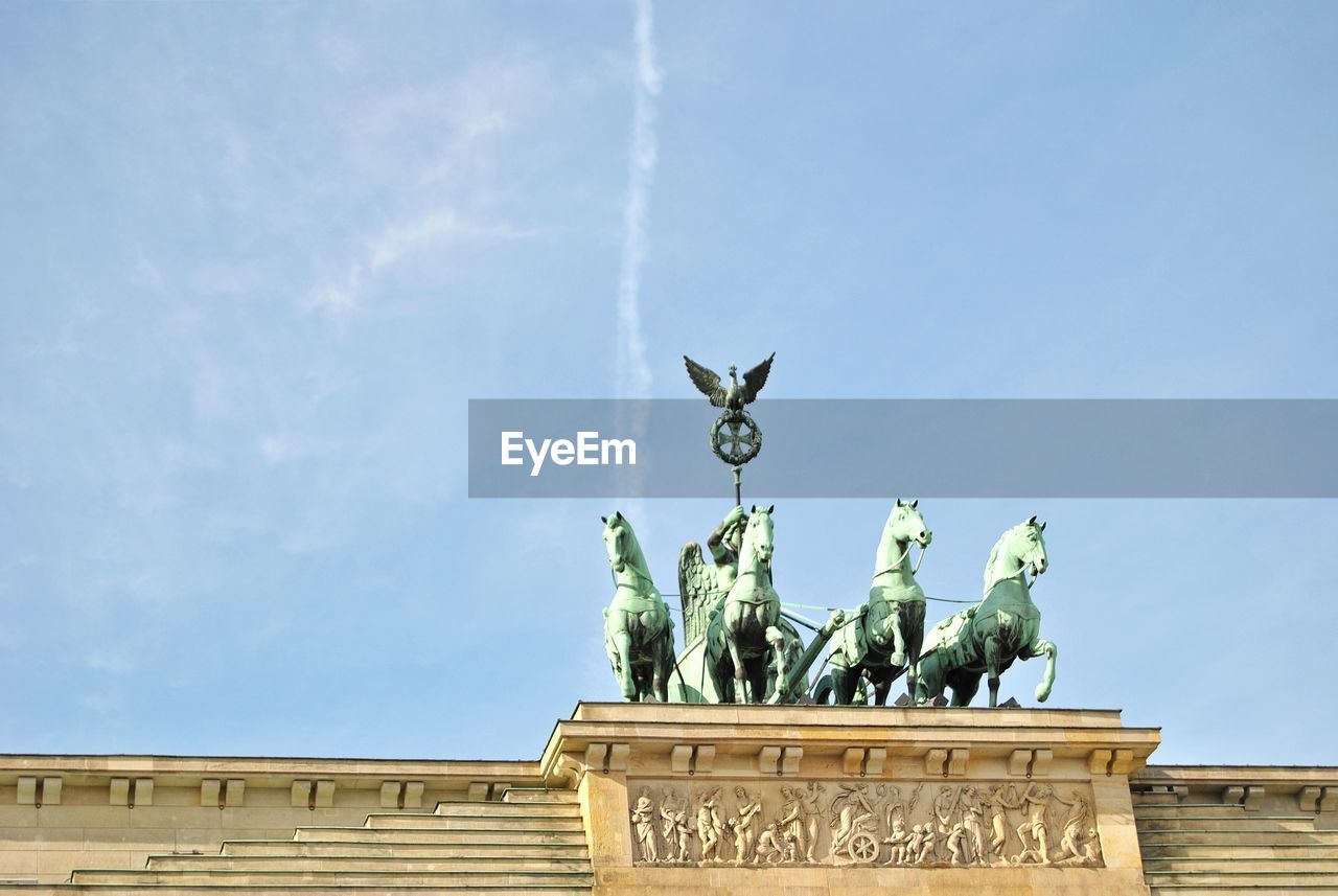 Low angle view of brandenburg gate against blue sky