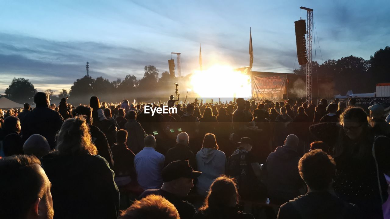 CROWD AT MUSIC CONCERT AGAINST SKY