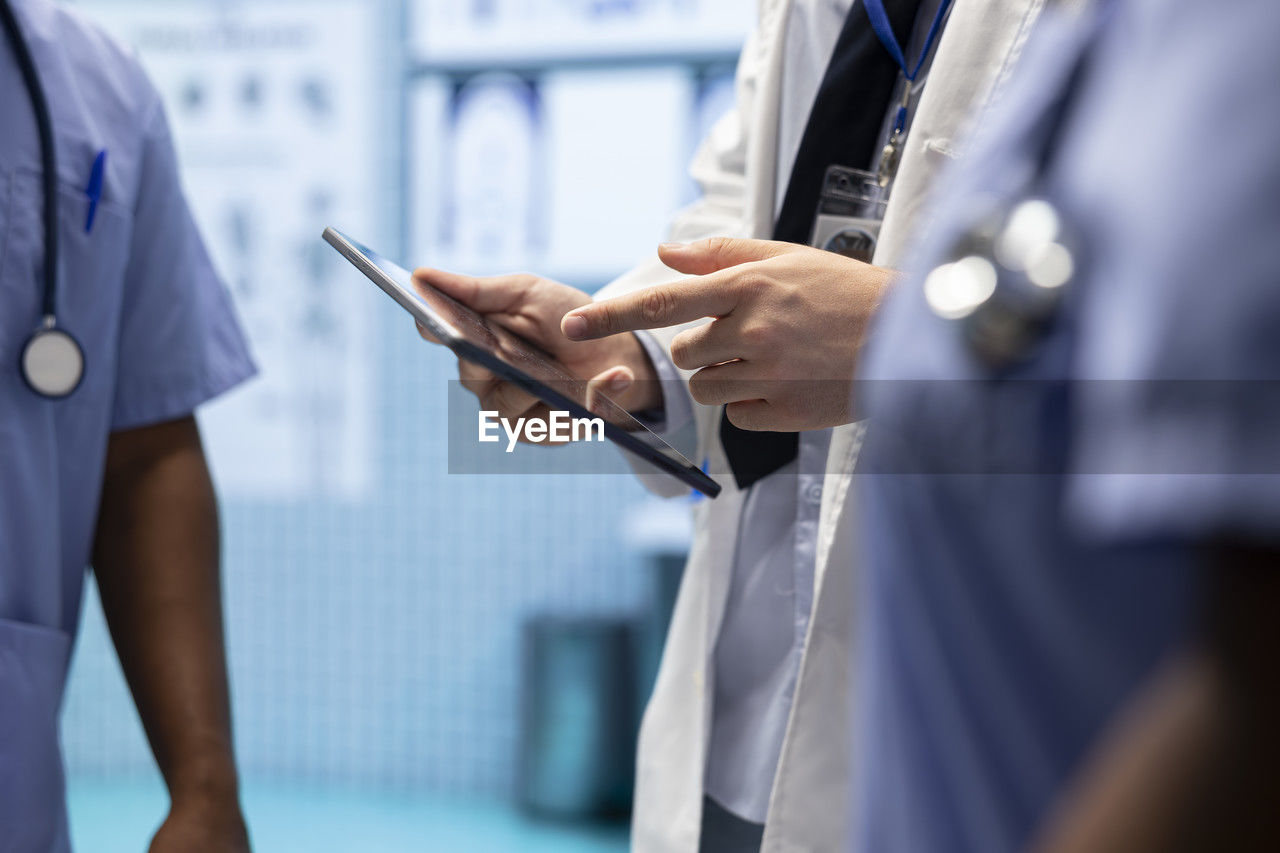 midsection of man using smart phone