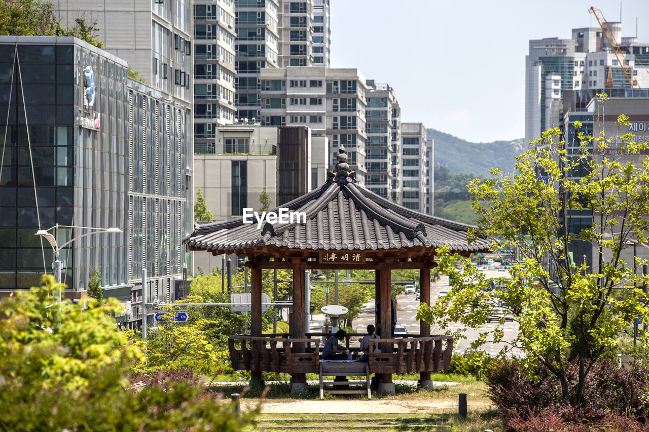 VIEW OF BUILT STRUCTURE WITH TREES IN BACKGROUND