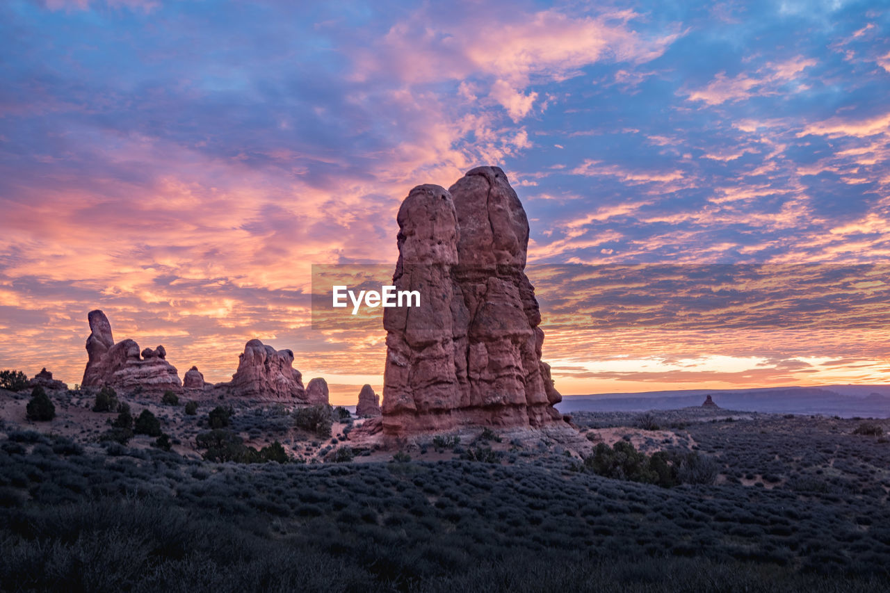 Rock formations against sky during sunset