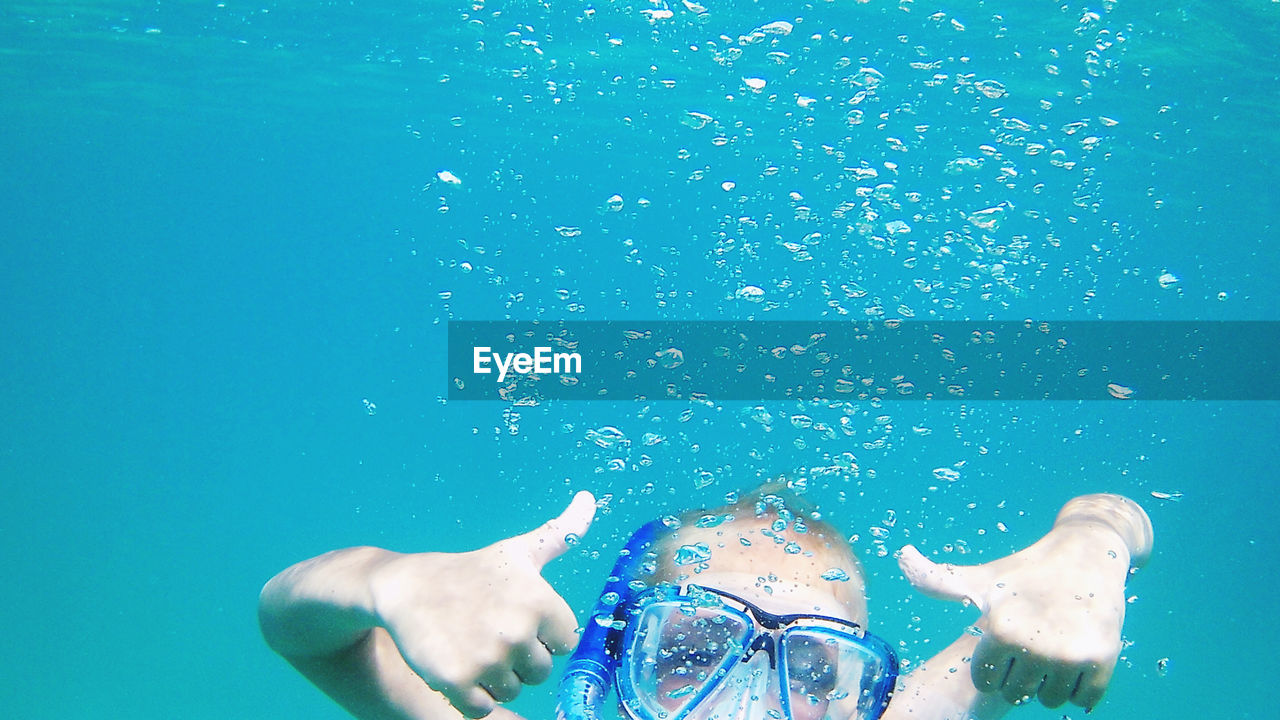 MAN SWIMMING IN POOL