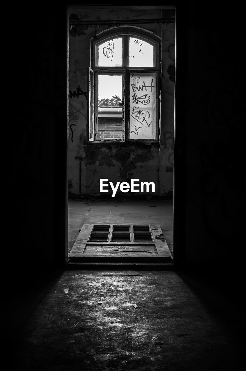 Window seen through entrance of abandoned house