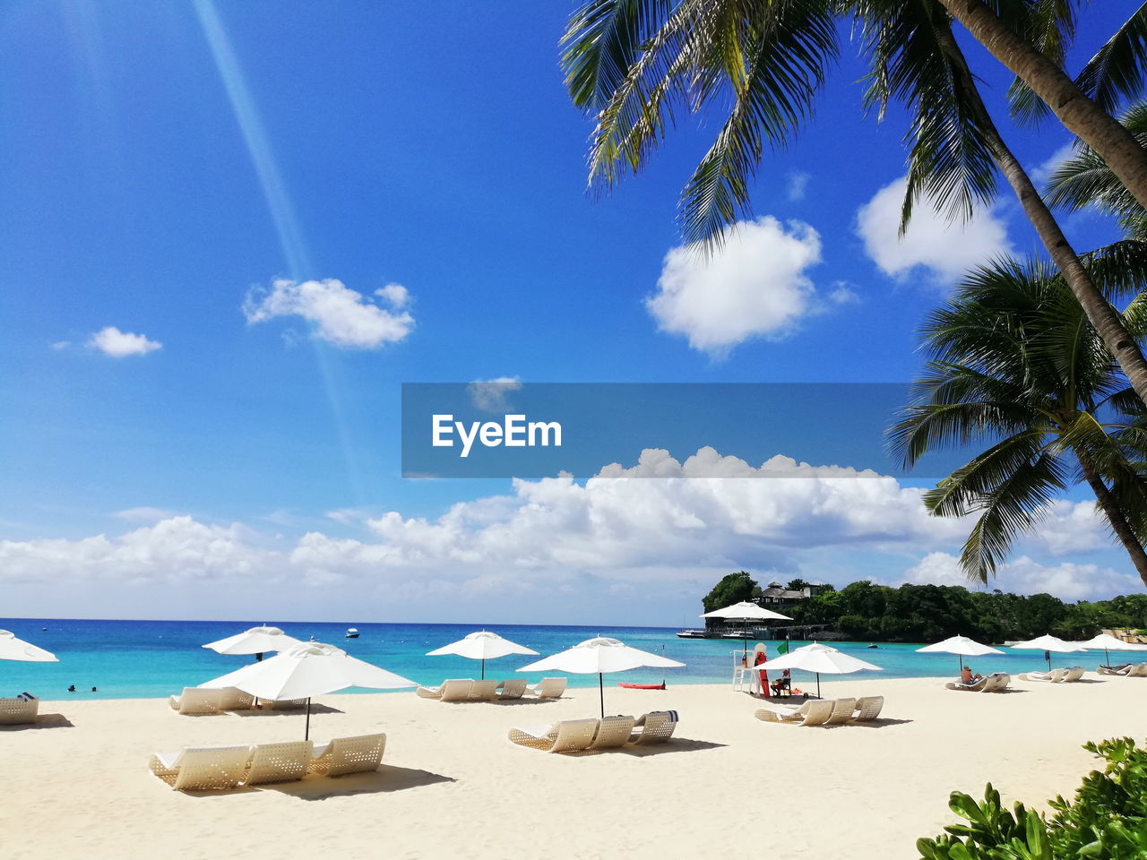 SCENIC VIEW OF BEACH AGAINST BLUE SKY