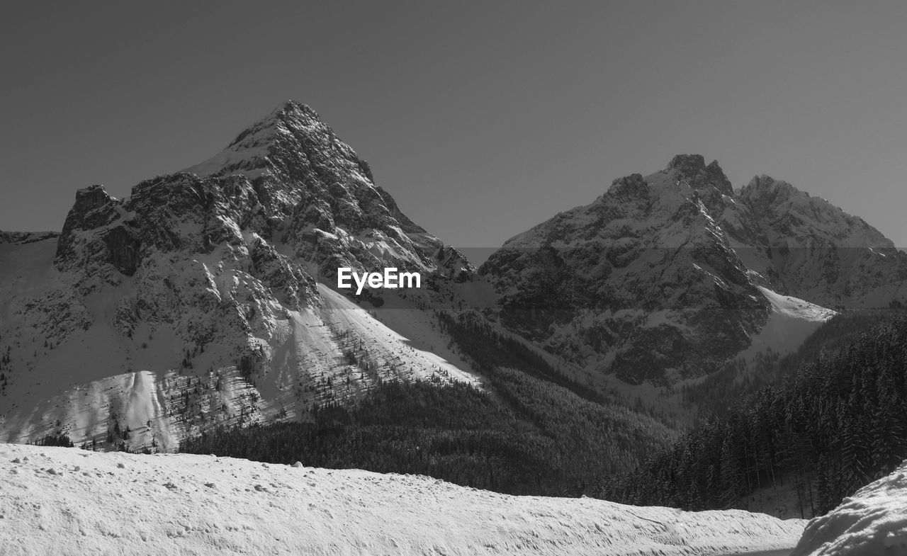 Scenic view of snowcapped mountains against clear sky