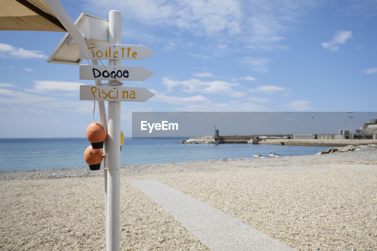 INFORMATION SIGN ON SHORE AGAINST SKY