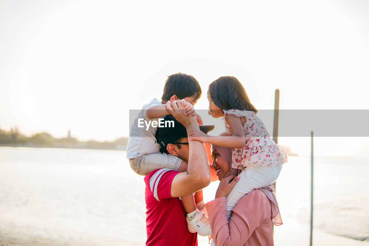 Side view of family against sky