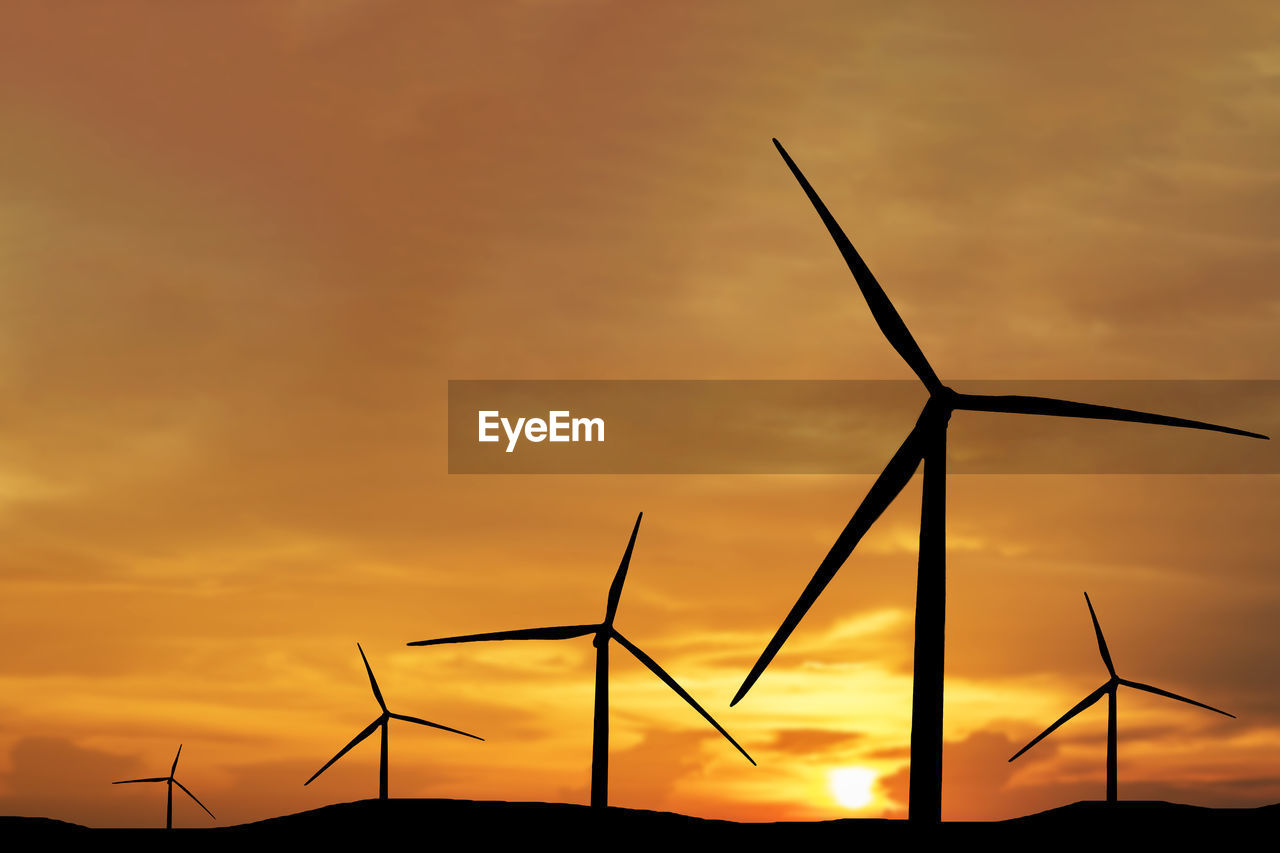 low angle view of silhouette trees against orange sky