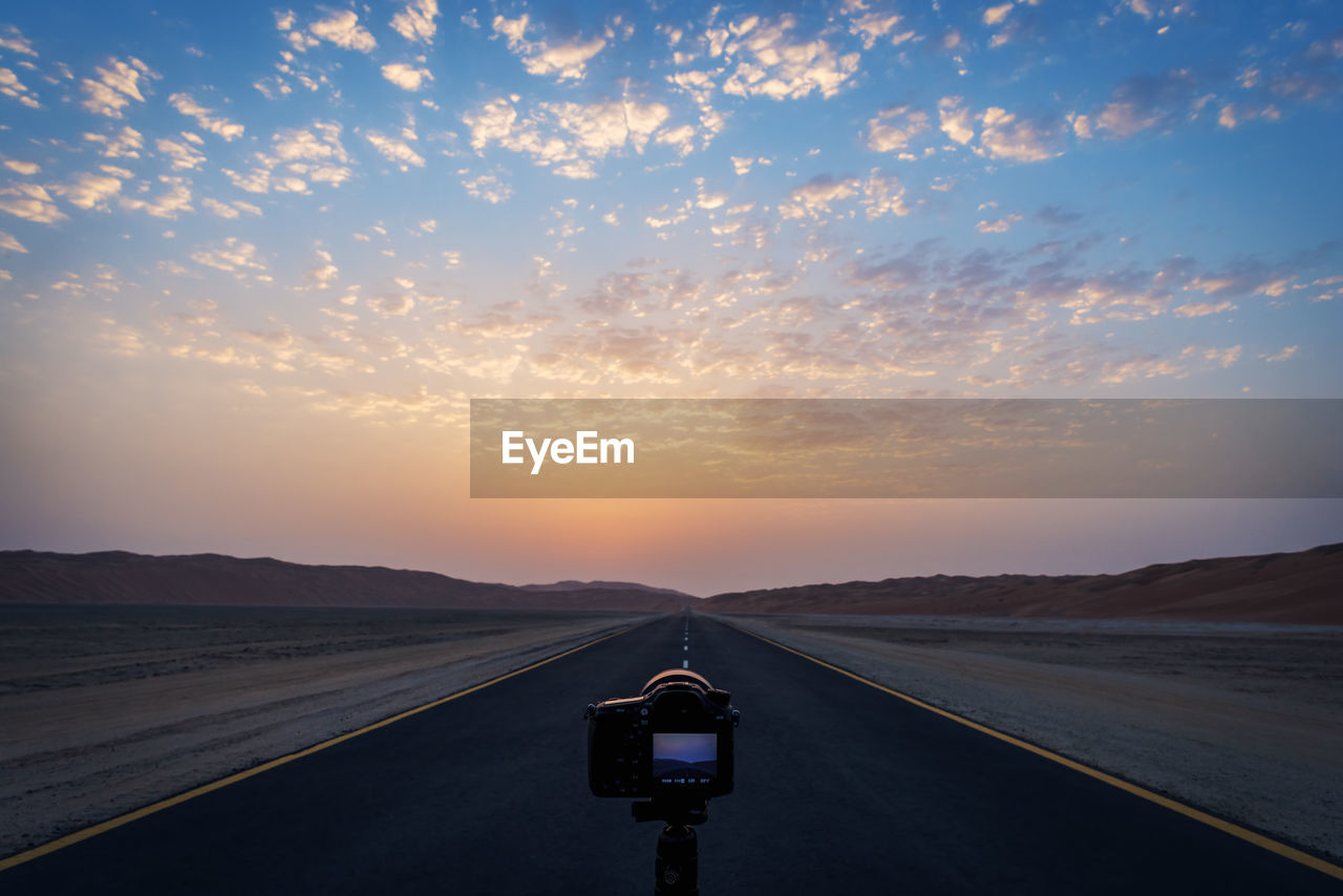 Camera against sky during sunset