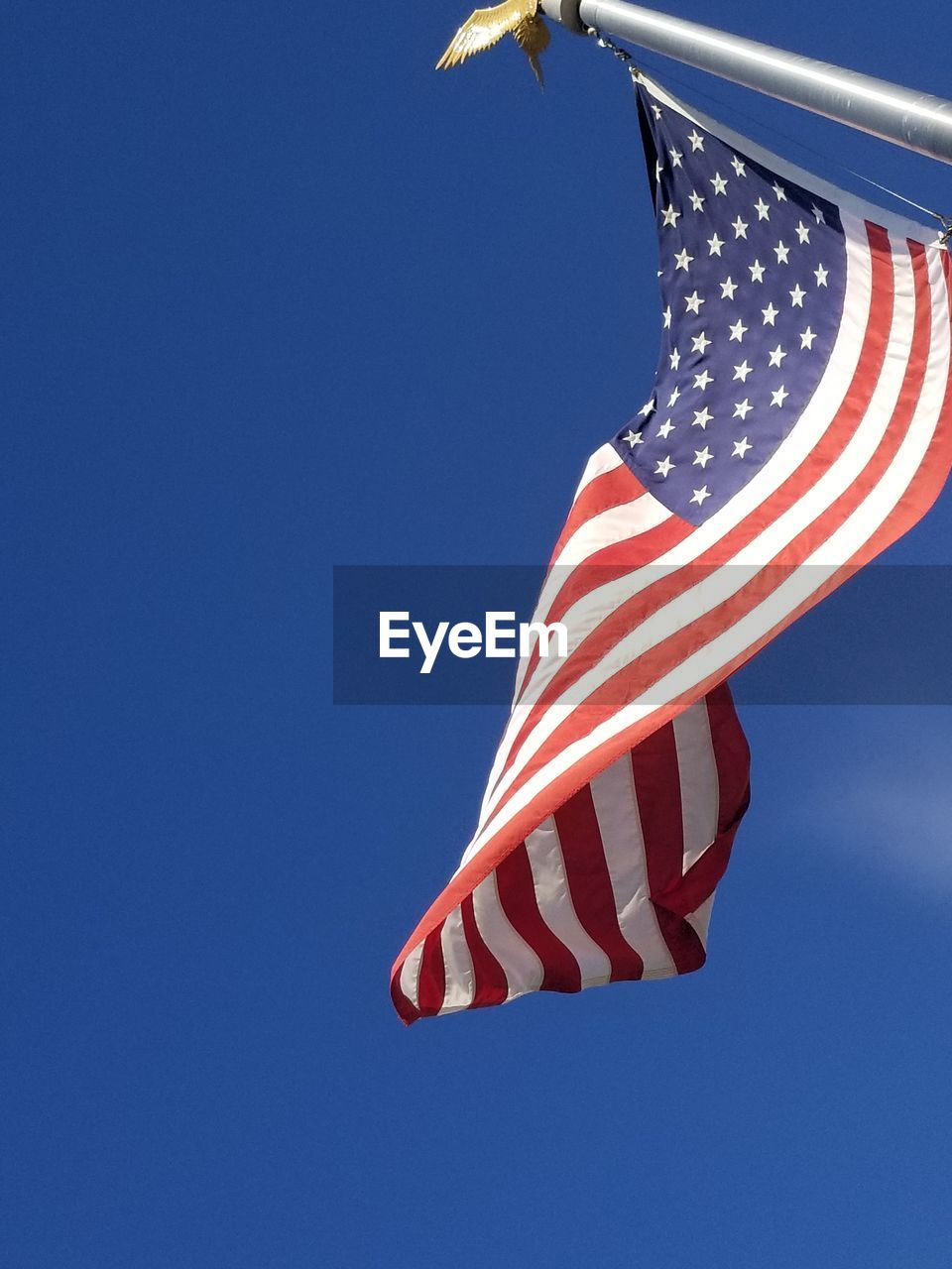 LOW ANGLE VIEW OF FLAG AGAINST CLEAR SKY