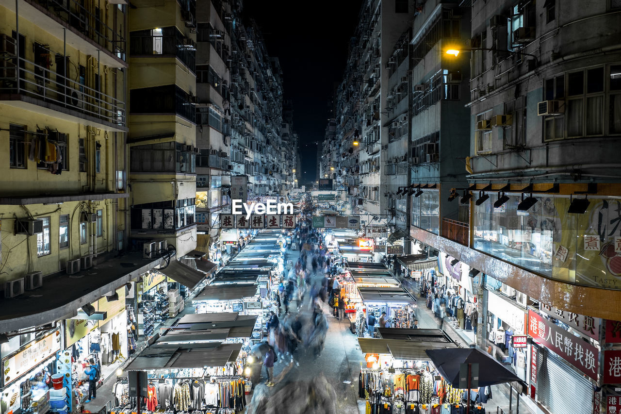 Market in illuminated city at night