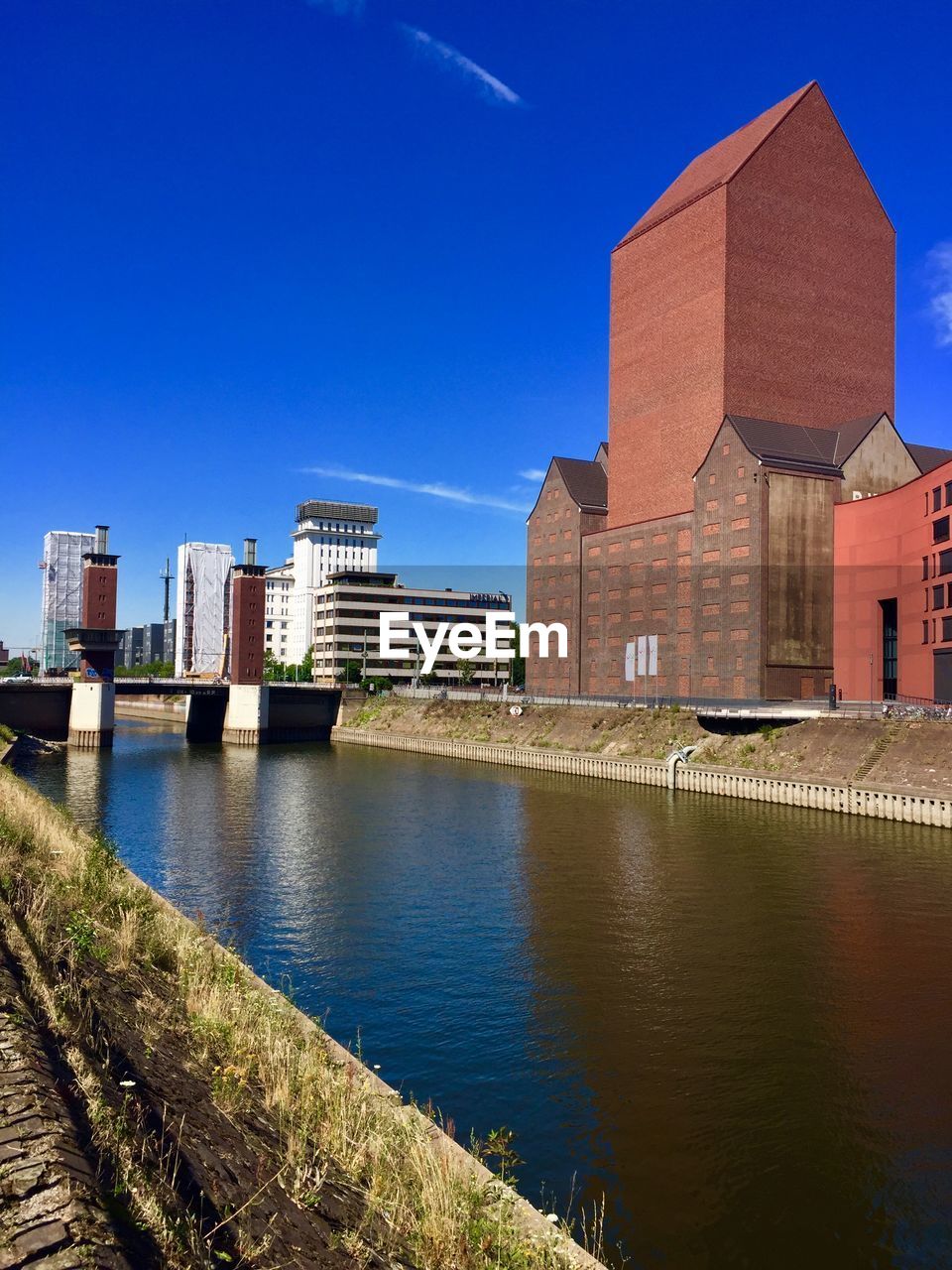 Buildings in city against blue sky