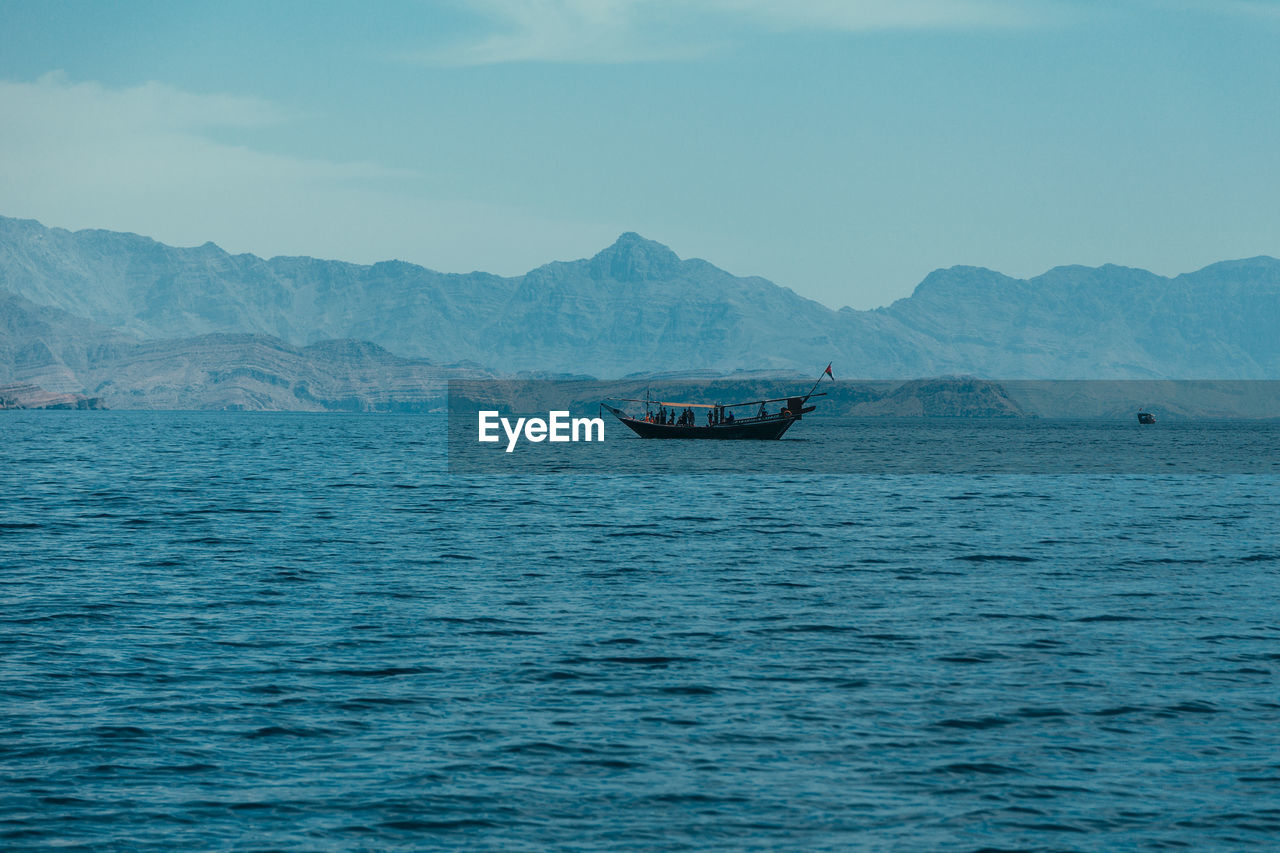 Boat in sea against sky