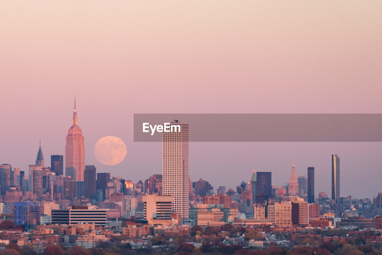 Cityscape against sky during sunset