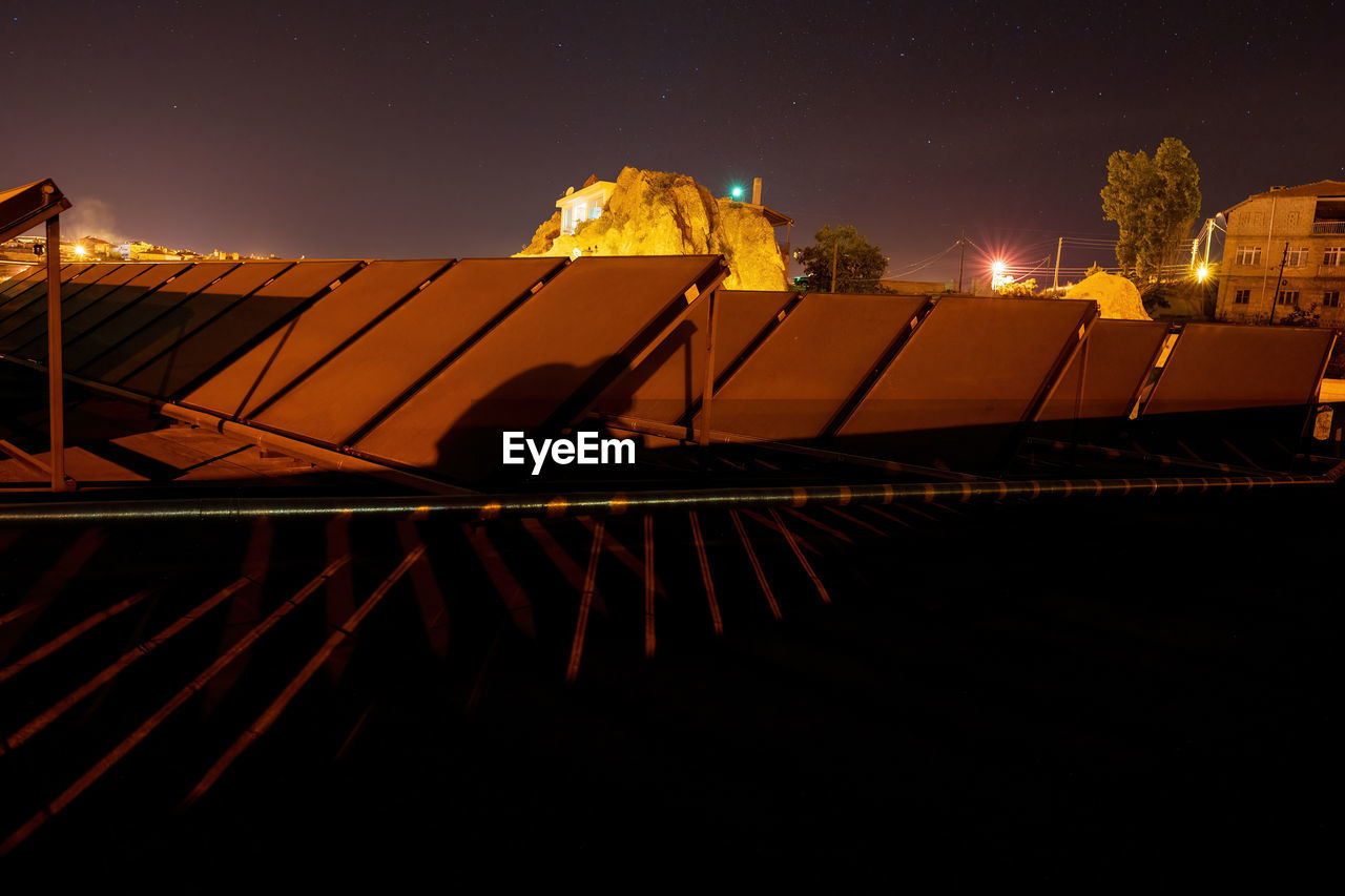 Astro photography of solar panel on a roof top against rocks and starry  night in cappadocia, turkey