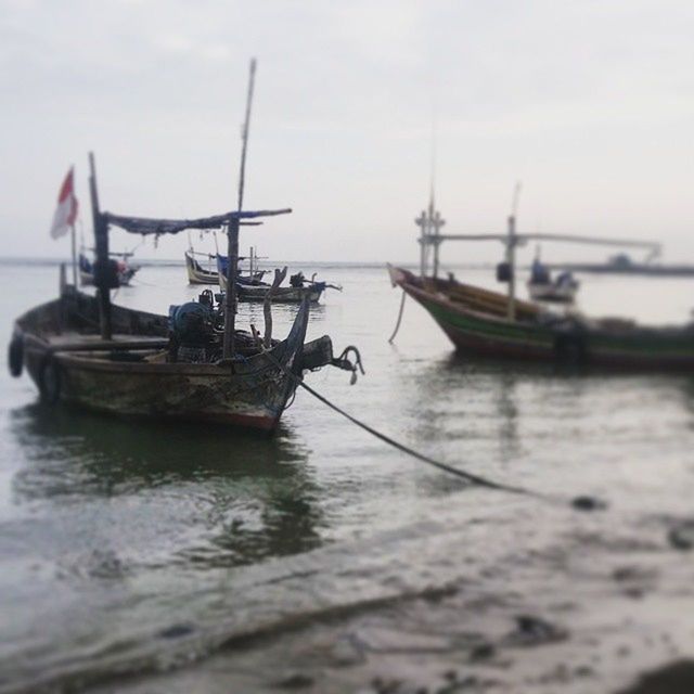 BOATS IN SEA WITH BOATS IN BACKGROUND