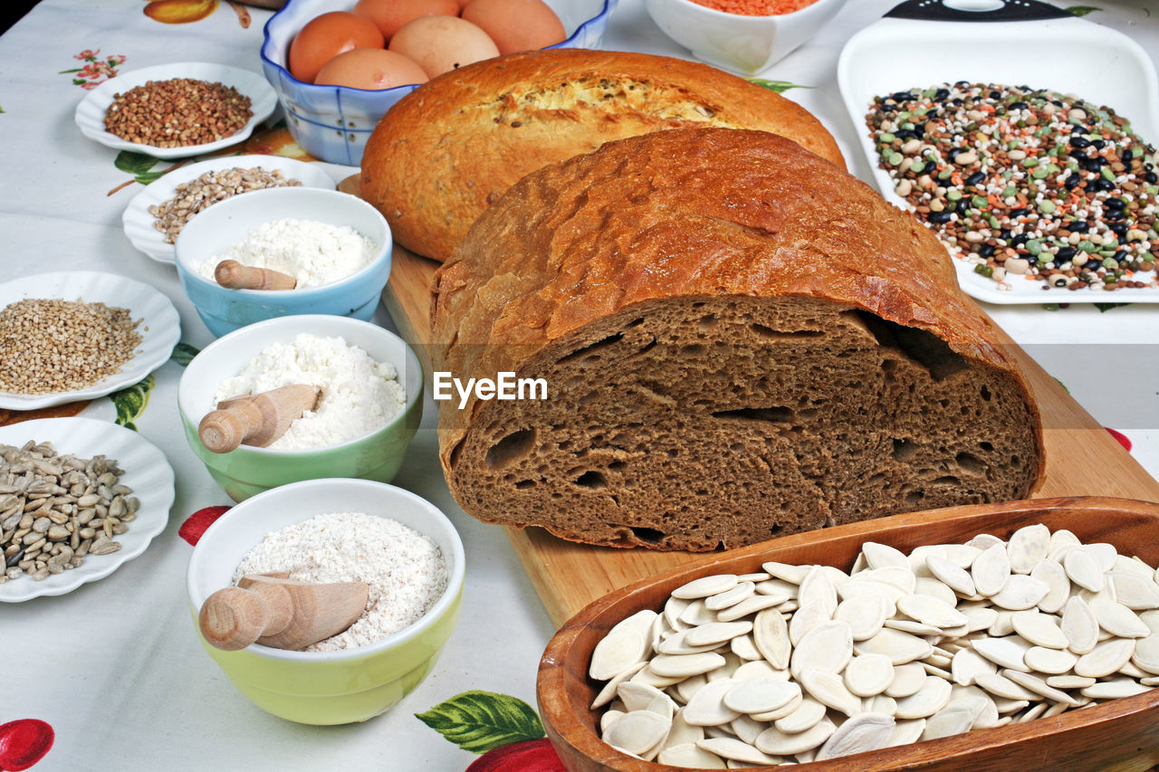 Close-up of bread and ingredients on tablecloth