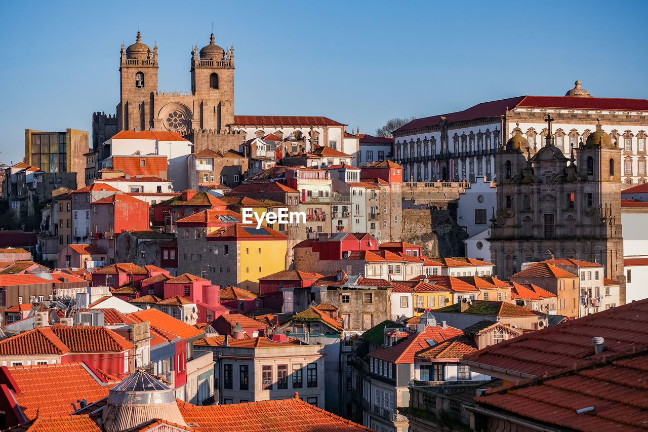 Buildings in city against clear sky