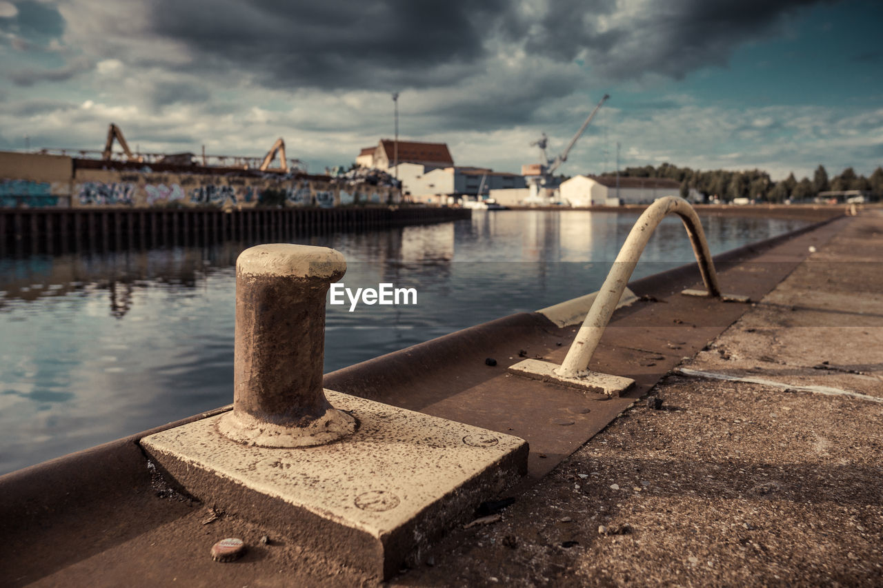 Close-up of bollards at harbor