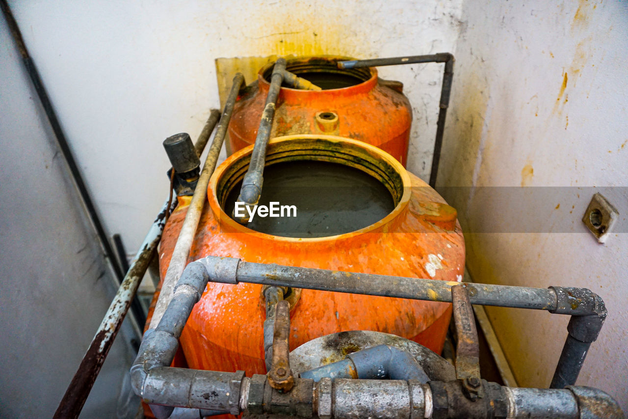 High angle view of dirty pipe with container