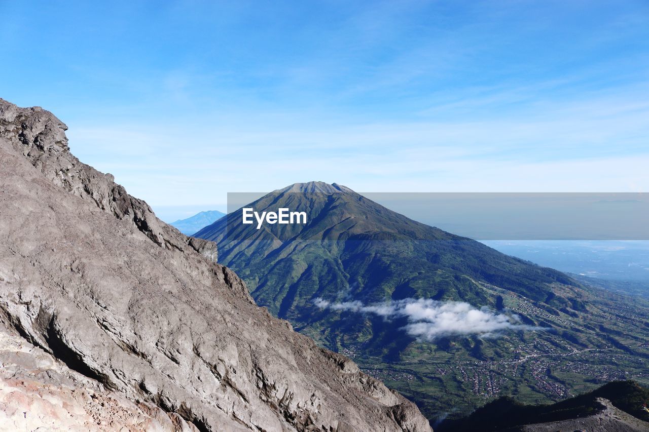 Scenic view of mountains against blue sky