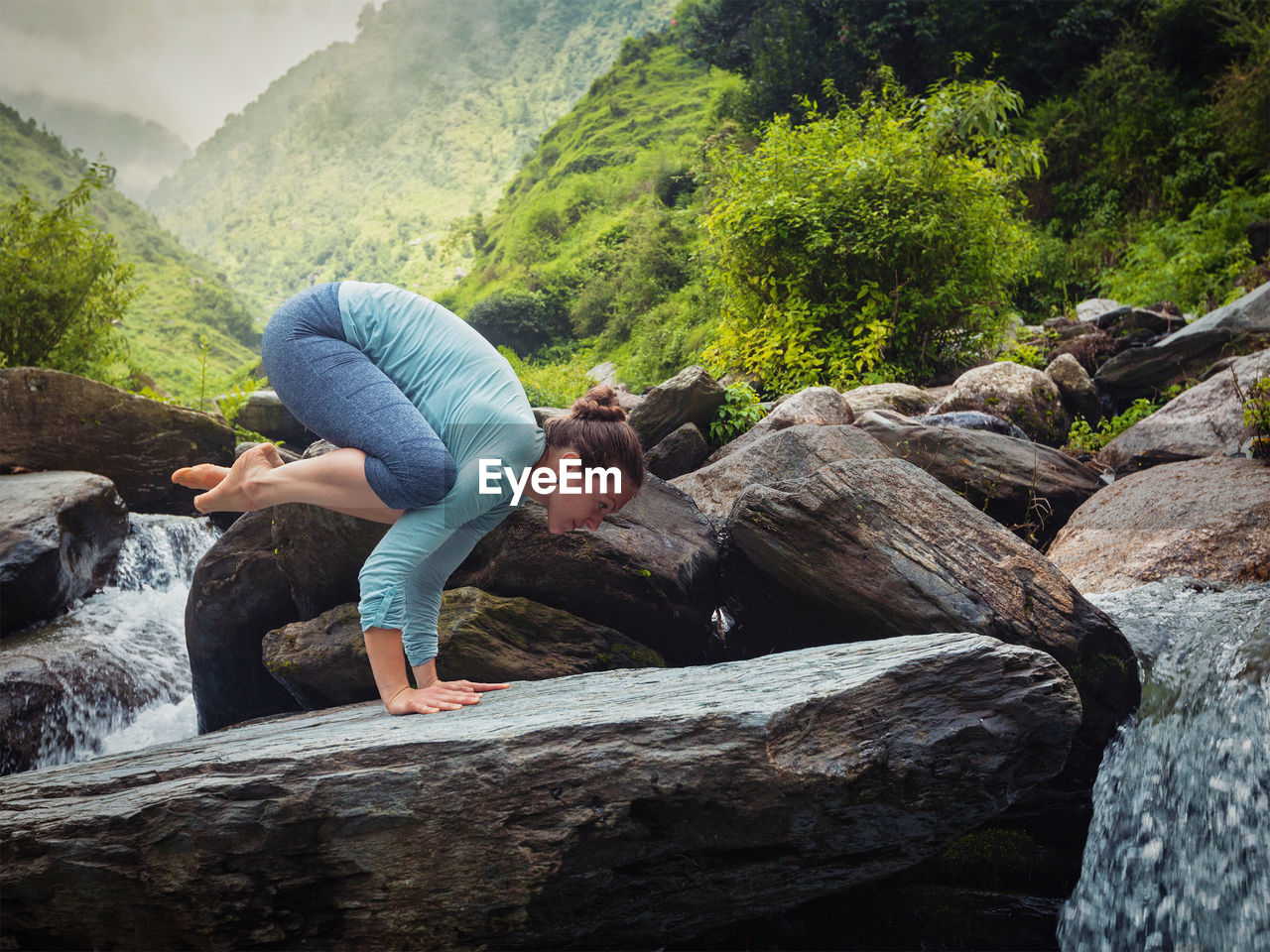 WOMAN RELAXING ON ROCK