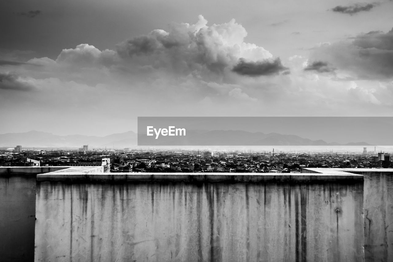 black and white, reflection, cloud, sky, monochrome, black, darkness, monochrome photography, white, water, architecture, horizon, nature, morning, built structure, environment, no people, sea, sunlight, landscape, mountain, building exterior, outdoors, day, light, scenics - nature, wood, city, pier, building