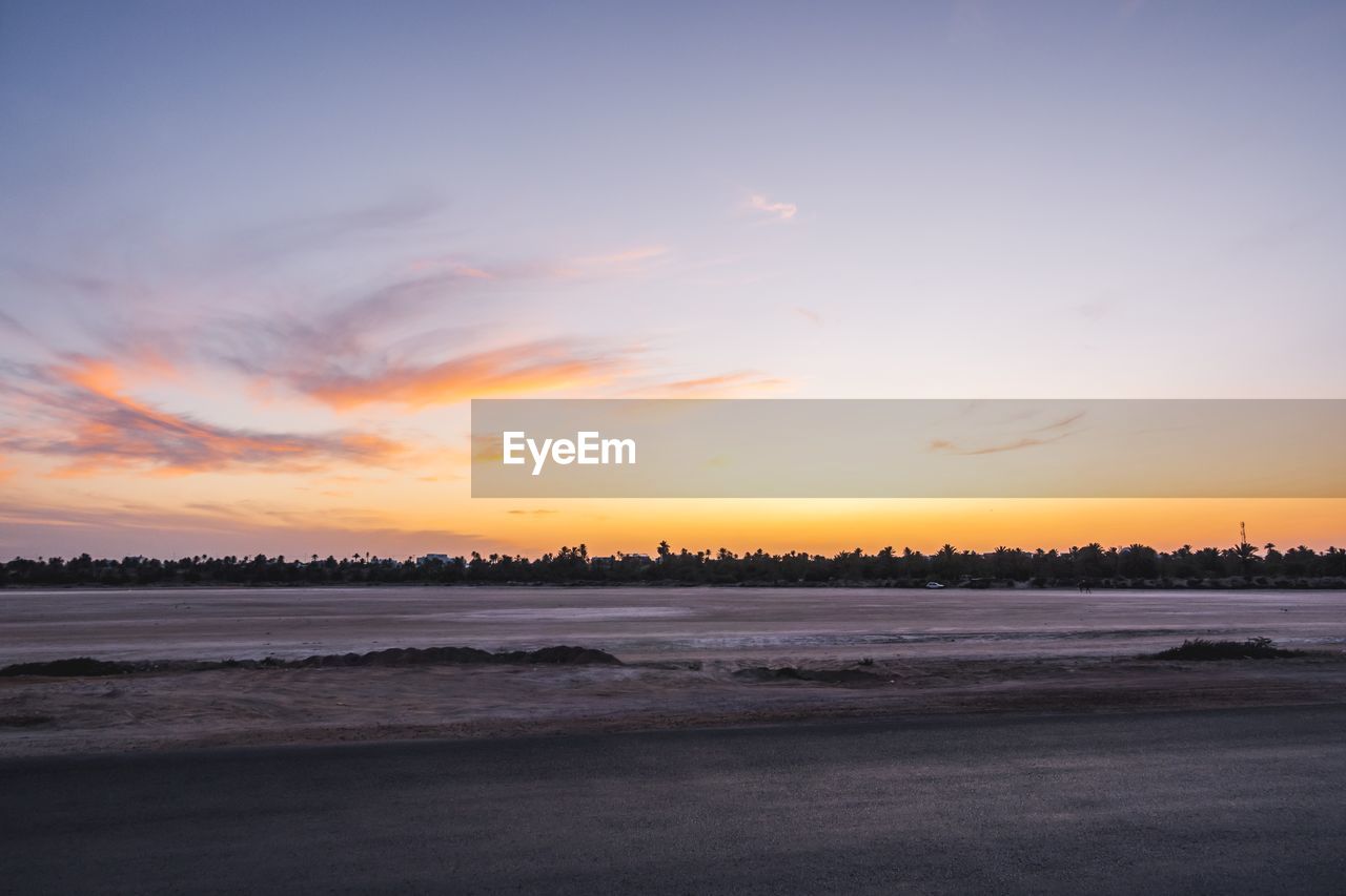 Scenic view of beach against sky during sunset