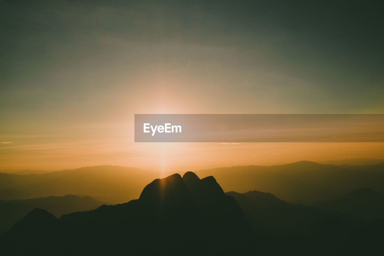 SILHOUETTE MOUNTAIN AGAINST SKY DURING SUNSET