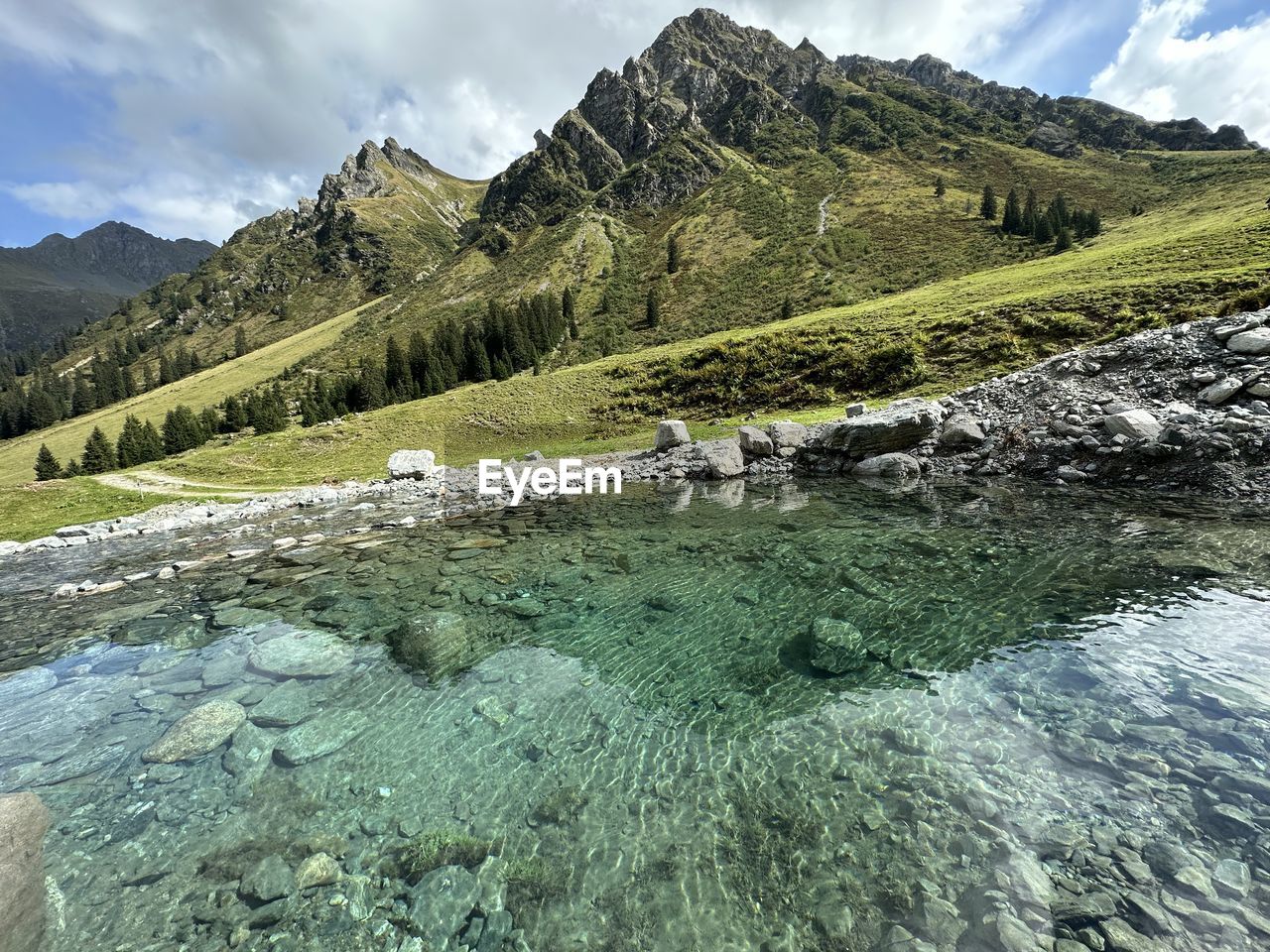 Scenic view of river amidst mountains against sky