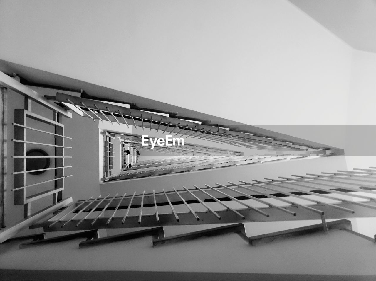 LOW ANGLE VIEW OF ESCALATORS ON TABLE AGAINST BUILDING