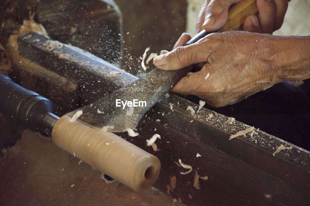 Close-up of hand chiseling wood