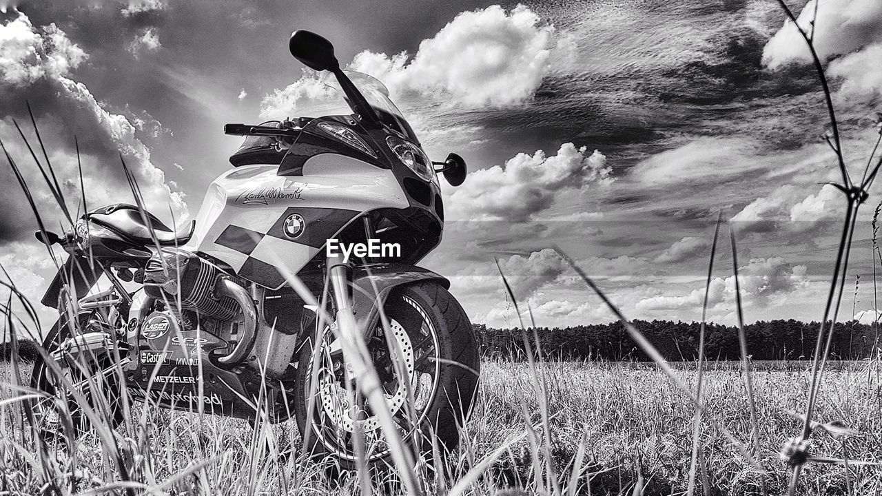 BICYCLE ON FIELD AGAINST SKY