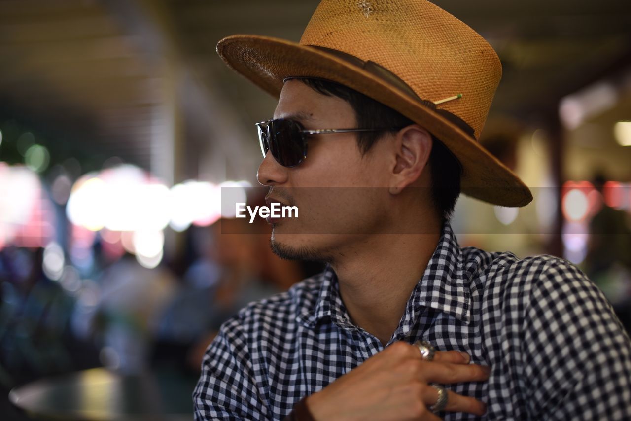 Portrait of man wearing sunglasses and hat