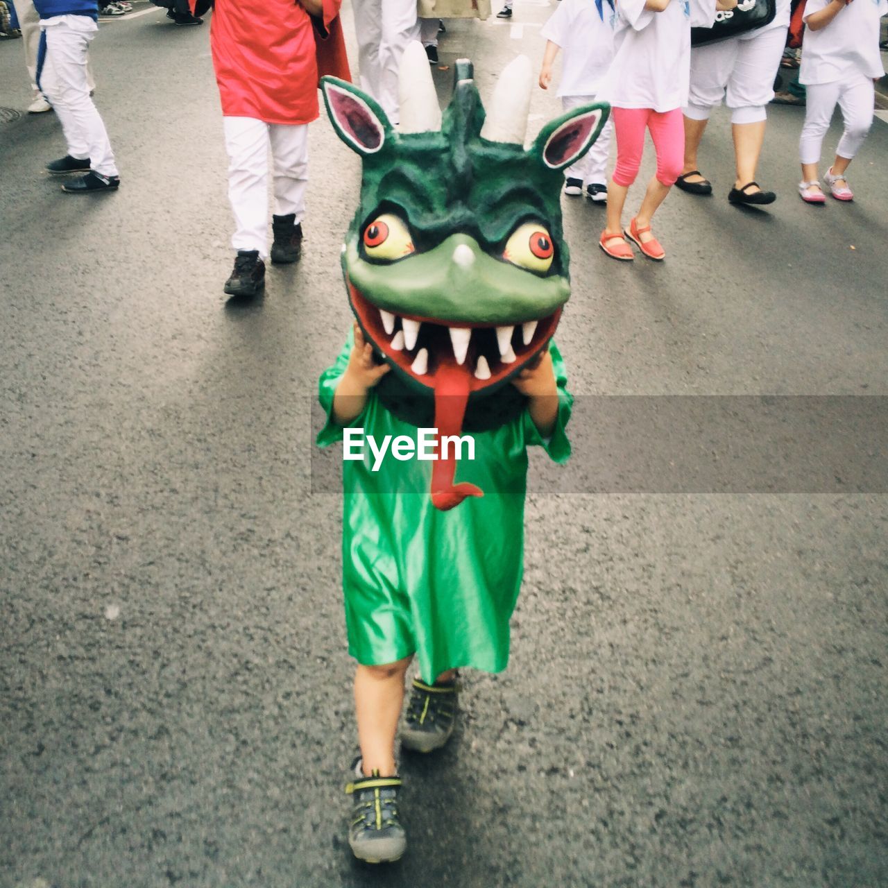 High angle view of kid with mask walking on street