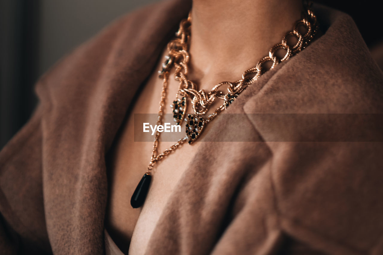 Gold chain hanging on a woman's neck. beautiful elegant luxury jewelry accessories